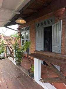 a bench on the porch of a house at Vintekta Cottage in Weligama