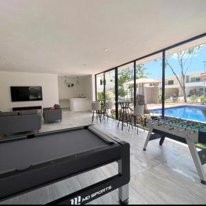 a living room with a pool table and a tv at Vacation Home in Playa Del Carmen in Playa del Carmen +23 photos