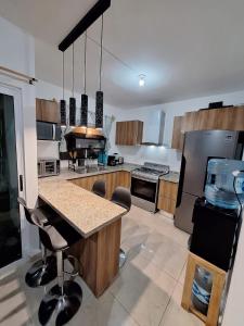 a large kitchen with a island in the middle at Vacation Home in Playa Del Carmen in Playa del Carmen
