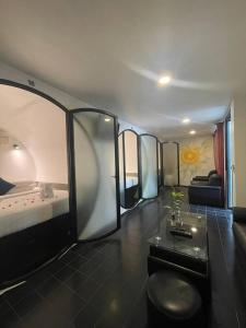 a room with a room with a bed and a couch at Tunnel Urban Retreat in Siem Reap