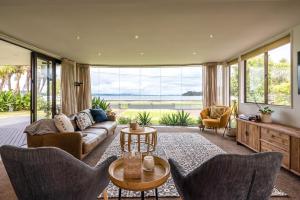 a living room with a couch and chairs at Alhambra - Stay Waiheke in Oneroa