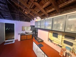 a large kitchen with wooden counters and windows at Bucolic Resort in Panamaram