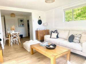 a living room with a couch and a coffee table at Bach 14 - Stay Waiheke in Blackpool