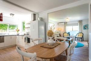 a kitchen and dining room with a table and chairs at Bach 14 - Stay Waiheke in Blackpool