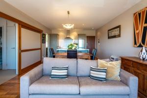 a living room with a couch and a table at The Sands - Apartment 12 - Stay Waiheke in Onetangi