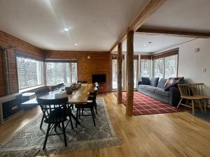 a living room with a table and a couch at Pine House in Rankoshi