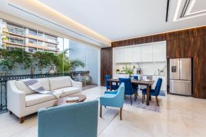 a living room with a couch and a table and chairs at Pier 57 Romantic Zone Luxury Condo 209 in Puerto Vallarta