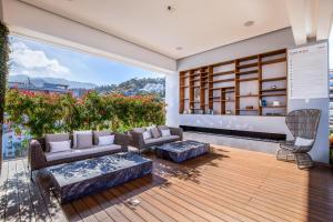 a living room with furniture and a large window at Pier 57 Romantic Zone Luxury Condo 209 in Puerto Vallarta +22 photos