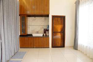 a bathroom with a sink and a wooden cabinet at Meg's Homestay in Jairāmpura