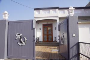 a house with a purple door with a snake on it at Meg's Homestay in Jairāmpura
