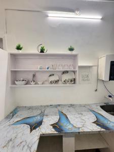 a room with a table with dolphins painted on it at Casa Fiesta Pondy in Pondicherry +9 photos