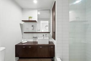 a bathroom with a sink and a mirror at Paradiso Resort by Kingscliff Accommodation in Kingscliff +90 photos