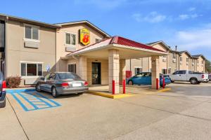 a car parked in front of a gas station at Super 8 by Wyndham Bloomington University Area in Bloomington
