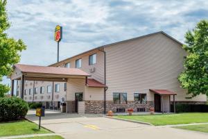 Super 8 by Wyndham Normal Bloomington في بلومينغتون: مبنى مع علامة على جانبه