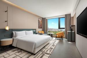 Ένα ή περισσότερα κρεβάτια σε δωμάτιο στο Days Hotel by Wyndham Haikou Meilan Airport +10 φωτογραφίες