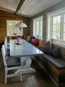 a living room with a table and a couch at Mountain Cabin With Views Of Bonsenås in Tuddal +27 photos