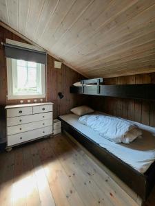 a bedroom with a bunk bed and a window at Mountain Cabin With Views Of Bonsenås in Tuddal