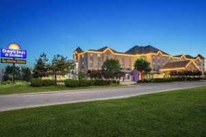 a hotel with a sign in front of a street at Days Inn & Suites by Wyndham West Edmonton in Edmonton