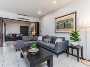 Paradiso Resort by Kingscliff Accommodation في كينغسكليف: غرفة معيشة بها أريكة وطاولة