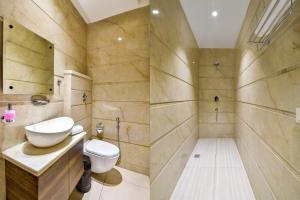a bathroom with a toilet and a sink at Hotel SG Continental Amritsar !! Prime Location ! Parking ! Open Terrace in Amritsar +14 photos