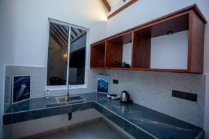 a kitchen with a sink and a counter top at Ceylon Princes Villa in Ahangama +40 photos