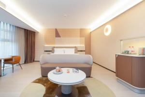 Ένα ή περισσότερα κρεβάτια σε δωμάτιο στο Orange Hotel Chengdu Sichuan Normal University Subway Station