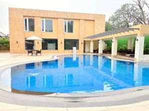 a large swimming pool in front of a building at Jajati Courtyard in Jajpur Road