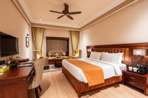 a hotel room with a bed and a desk at Jajati Courtyard in Jajpur Road