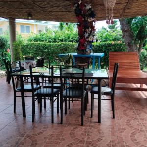 a table and chairs with a vase of flowers on it at M-J Room Rental in Alcoy