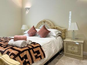 Royal Border Retreat في بيرويك أبون تويد: غرفة نوم بها سرير وطاولة ومصباح