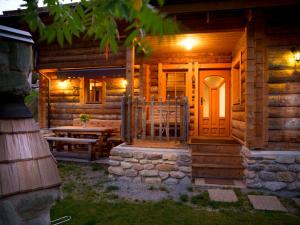 a log cabin with a porch and a wooden door at Chalet Steinbock, St Martin am Tennengebirge in Sankt Martin am Tennengebirge