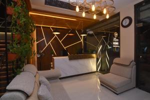 a lobby with two chairs and a waiting room at Hotel Lynx in Kumbakonam