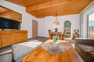 a living room with a couch and a table at Appartements Millinger in Lofer