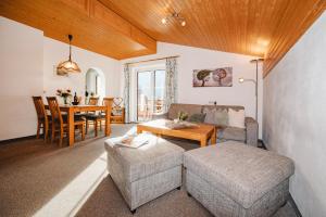 a living room with a couch and a table at Appartements Millinger in Lofer