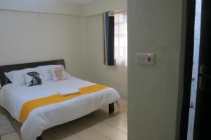 Postel nebo postele na pokoji v ubytování Gratia Pad Nanyuki