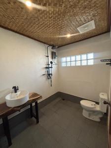 a bathroom with a sink and a toilet at Jungle Hostel in Puerto Princesa City +17 photos