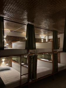 a group of bunk beds in a room at Jungle Hostel in Puerto Princesa City