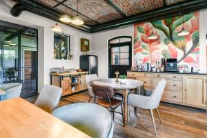 a dining room with a table and chairs at La Ceriseraie in La Gorgue