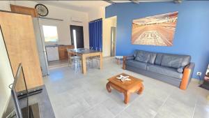 a living room with a couch and a table at Résidence La Clé des Champs in Clam