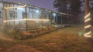 une maison avec des lumières sur son côté la nuit dans l'établissement Rr resort, à Araku