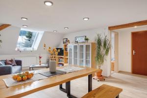 a living room with a table and a couch at Haus an der Breg in Vöhrenbach