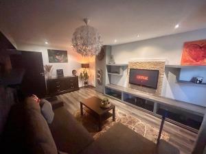 a living room with a couch and a fireplace at Zuzu’s home in Râşnov