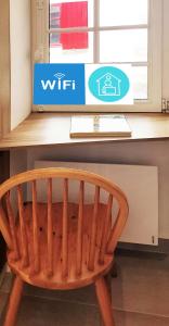 a wooden chair sitting in front of a desk at Le refuge du prieuré - Les Gîtes de la Côte d'Amour in Batz-sur-Mer +13 photos