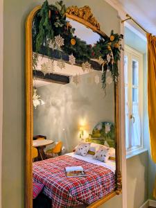 a large mirror in a bedroom with a bed at Il Sonetto - Boutique Apartment Suite in Mantova
