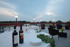 a table with wine bottles and plates on a patio at Tenuta del Vecchio Mulino in Motta deʼConti