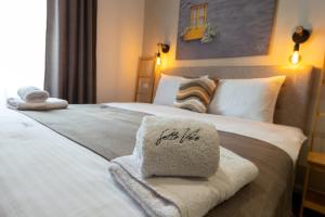 a hotel room with a bed with a towel on it at Sette Vele Rooms in Trieste