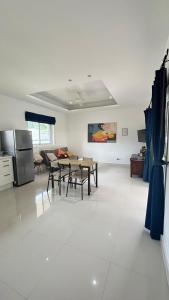 a kitchen and living room with a table and chairs at Villa Sun 4 in Mae Nam