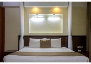 Giường trong phòng chung tại The Pinecone Hotel Kisumu +5 ảnh