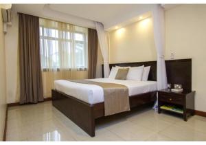 Giường trong phòng chung tại The Pinecone Hotel Kisumu