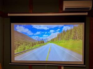 a television screen showing an empty road at Totono Amami in Karitachō